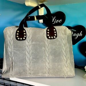 gray cable knit looking handbag that is gray in color- shoulder strap included.